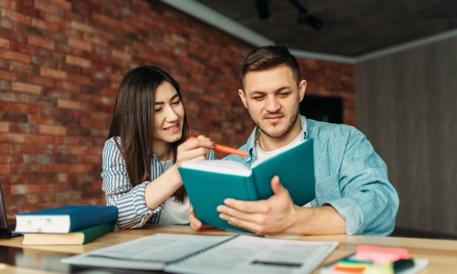 university-students-reading-textbook-together.jpg